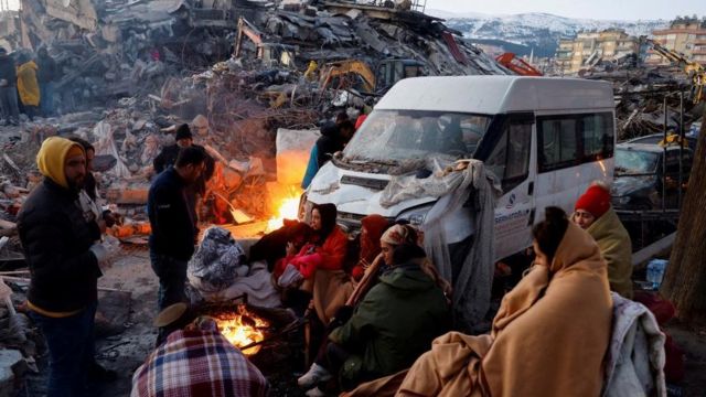 People sitting round fire