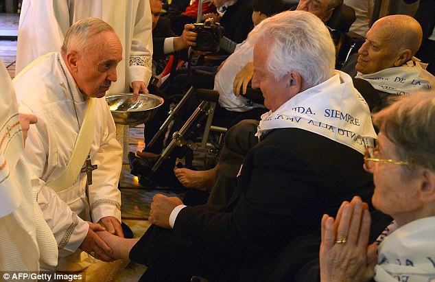 Humility: Pope Francis performs the traditional washing of the feet during a visit to a centre for disabled people today