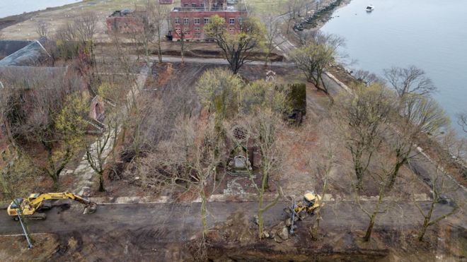 Heavy machinery digs a trench near two existing mass graves on Hart Island in the Bronx borough of New York City