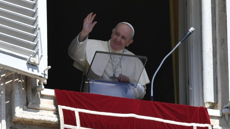Pope Francis waves from the window of the Apostolic Palace